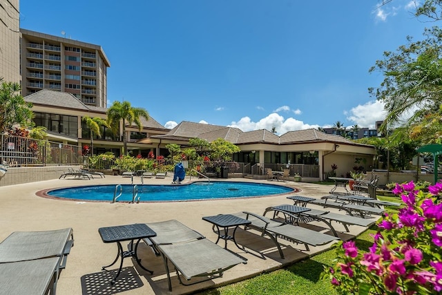 pool featuring a patio and fence