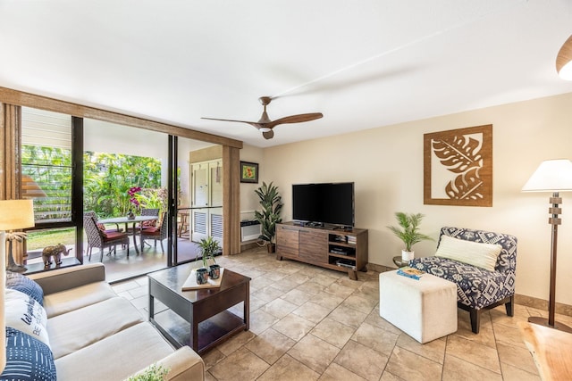 living area with expansive windows, baseboards, and ceiling fan