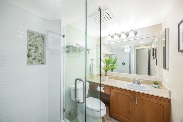 full bathroom with vanity, toilet, visible vents, and a stall shower