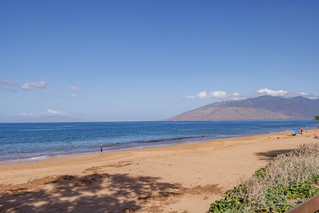 water view featuring a mountain view and a beach view