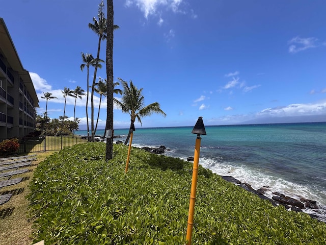 property view of water featuring fence