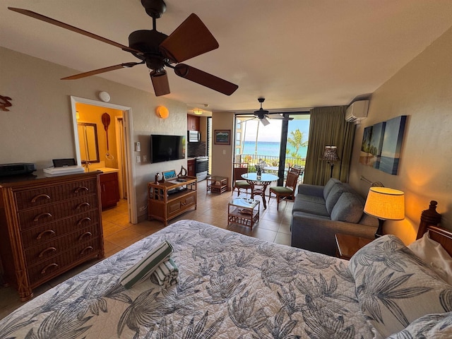 bedroom with light tile patterned flooring, ensuite bath, access to outside, and a wall mounted AC