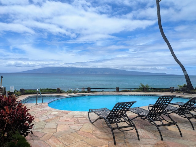 view of swimming pool with a mountain view and a patio