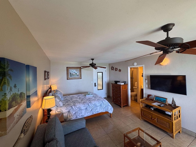 tiled bedroom featuring connected bathroom and ceiling fan