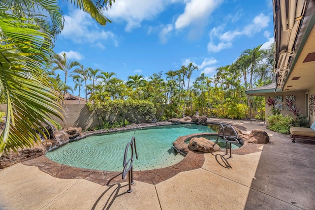 view of pool featuring a fenced backyard, a patio, a fenced in pool, and an in ground hot tub