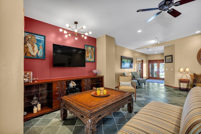 living room with vaulted ceiling, ceiling fan with notable chandelier, stone tile floors, baseboards, and recessed lighting