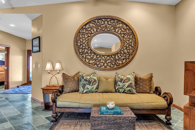living area with stone finish flooring, baseboards, and recessed lighting