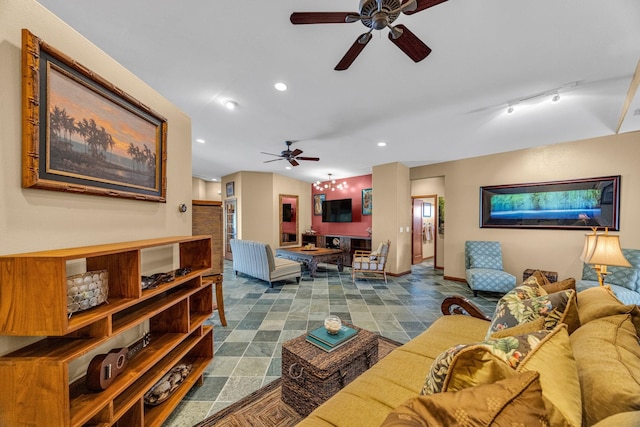 living area featuring baseboards, a ceiling fan, and recessed lighting