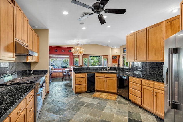 kitchen with recessed lighting, under cabinet range hood, a sink, high quality appliances, and a peninsula