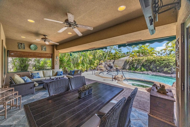 view of patio featuring outdoor lounge area, a ceiling fan, a fenced in pool, and an in ground hot tub