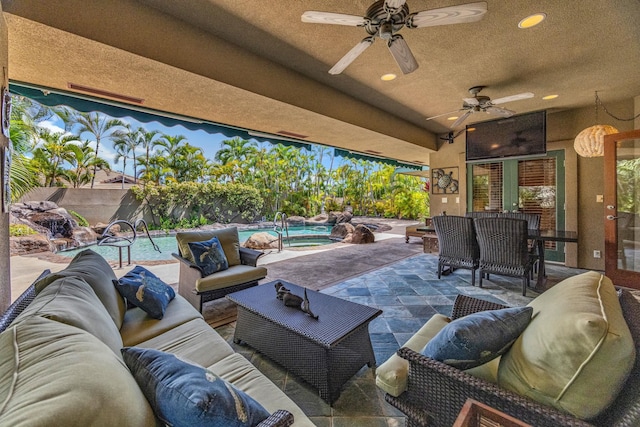 view of patio / terrace with an outdoor living space, ceiling fan, and an outdoor pool