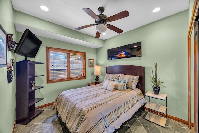 bedroom with ceiling fan, baseboards, stone finish floor, and recessed lighting