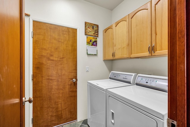 washroom with washing machine and clothes dryer and cabinet space