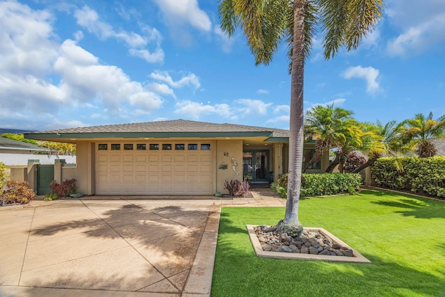 single story home featuring a garage, driveway, a front lawn, and stucco siding