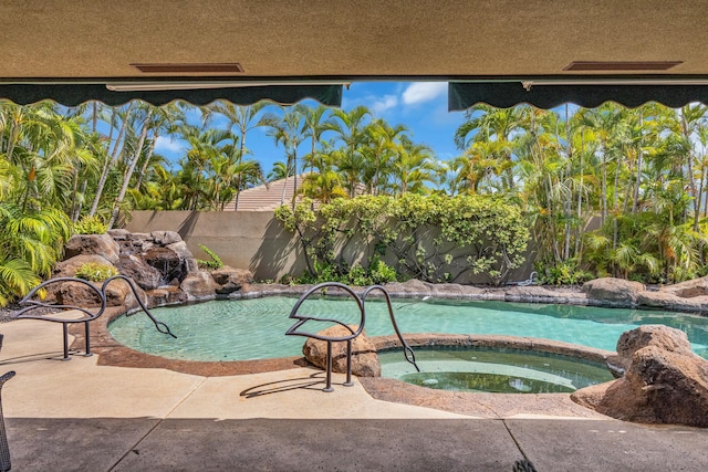 view of pool with a fenced in pool and an in ground hot tub