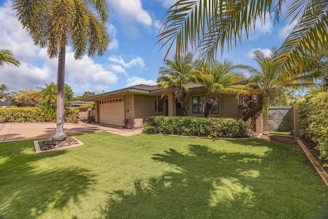 view of front of home featuring a garage, a front lawn, driveway, and stucco siding