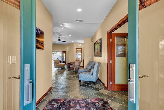 hall with recessed lighting, stone finish floor, visible vents, and baseboards