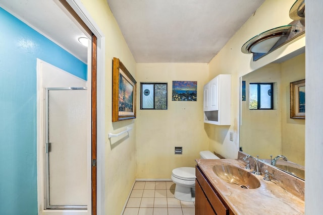 bathroom with a stall shower, baseboards, toilet, tile patterned flooring, and vanity