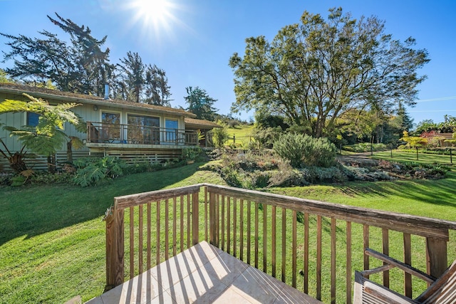 wooden terrace with a lawn