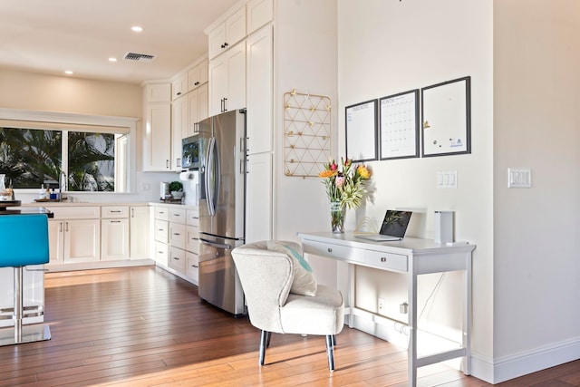 kitchen featuring sink, white cabinetry, appliances with stainless steel finishes, and light wood-type flooring