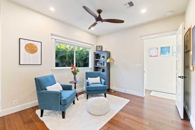 living area featuring ceiling fan and hardwood / wood-style floors