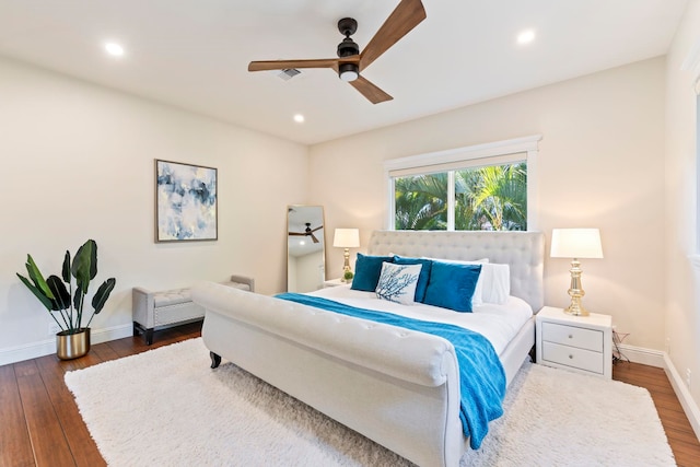 bedroom with ceiling fan and dark hardwood / wood-style flooring