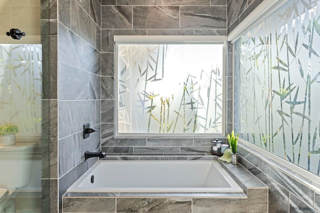 bathroom with tiled bath and toilet