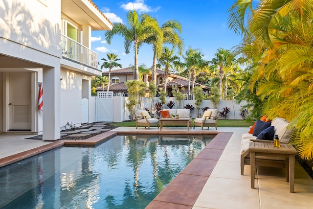 view of swimming pool with an outdoor living space and a patio