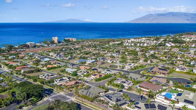 birds eye view of property with a water and mountain view