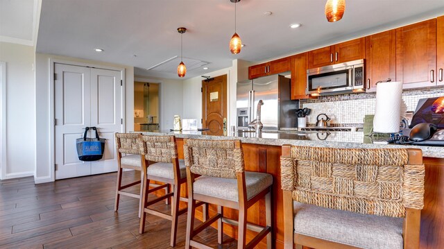 130 Kai Malina Pkwy Unit Nr1026, Lahaina, HI 96761 - kitchen with appliances with stainless steel finishes, dark wood-type flooring, backsplash, hanging light fixtures, and recessed lighting