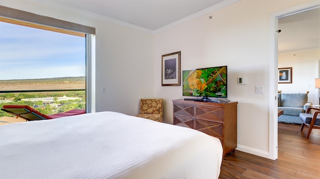 bedroom with dark hardwood / wood-style floors and crown molding