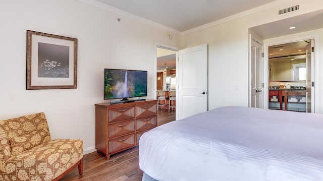 bedroom with ornamental molding and hardwood / wood-style flooring