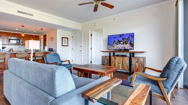 living room with ceiling fan, dark hardwood / wood-style floors, and crown molding