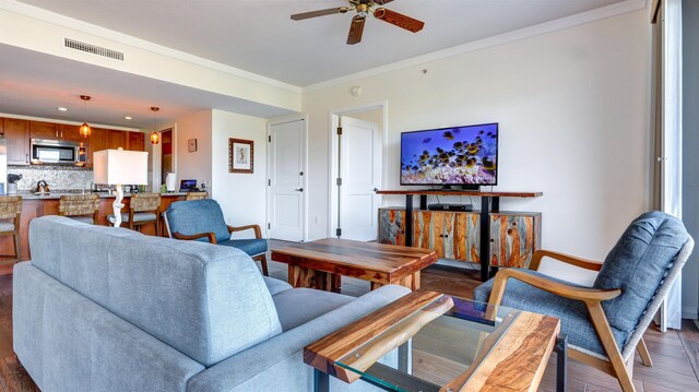 130 Kai Malina Pkwy Unit Nr1026, Lahaina, HI 96761 - living area featuring baseboards, ceiling fan, crown molding, and wood finished floors
