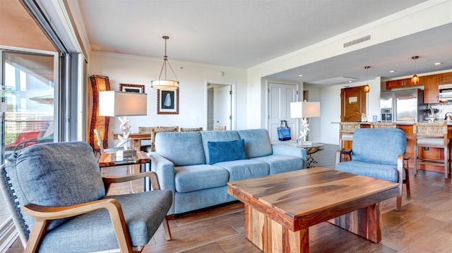 living room with ornamental molding and hardwood / wood-style floors