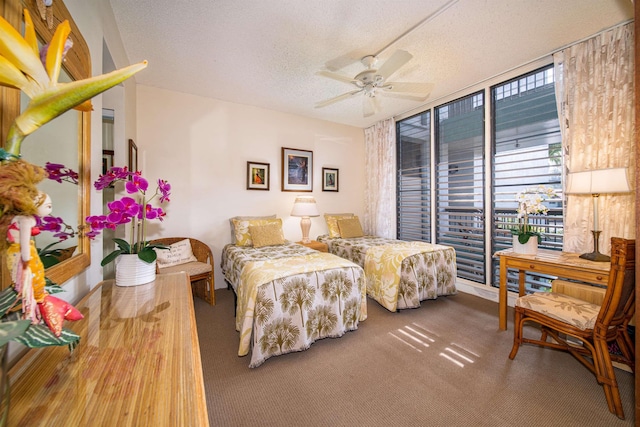 bedroom with hardwood / wood-style floors, ceiling fan, and a textured ceiling