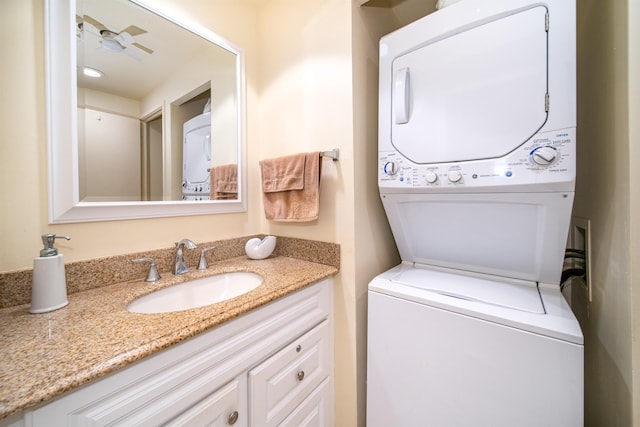 bathroom featuring ceiling fan, vanity, and stacked washing maching and dryer