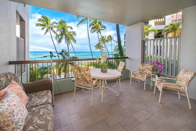 balcony with a beach view and a water view