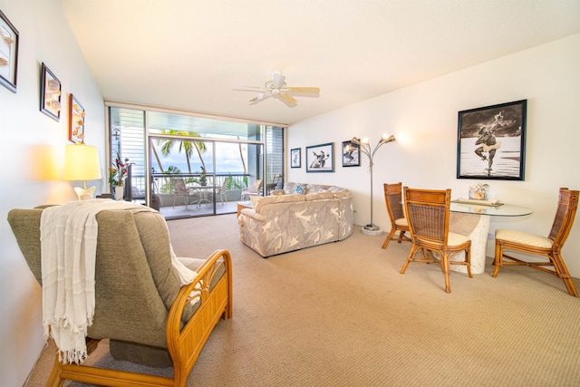 living room featuring ceiling fan and carpet