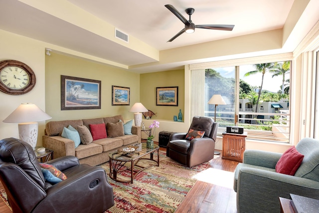 living room with ceiling fan and hardwood / wood-style flooring