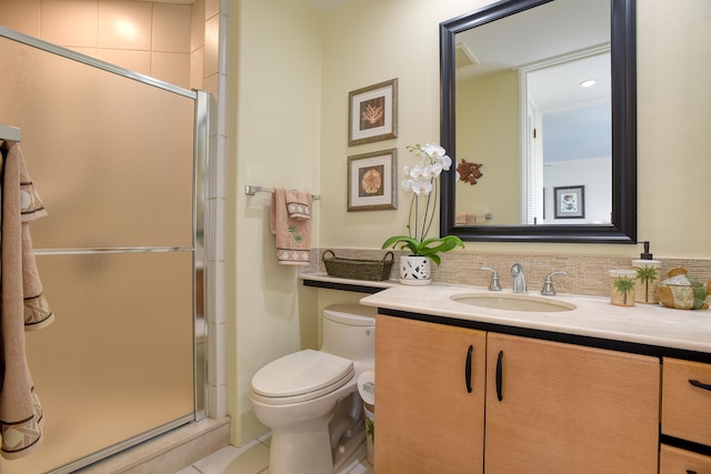 bathroom featuring vanity, toilet, and walk in shower