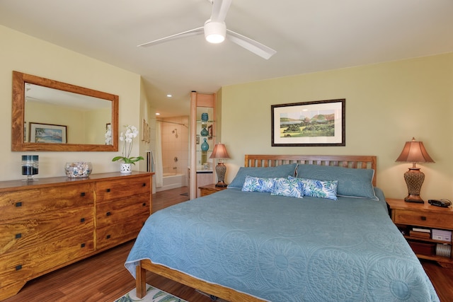 bedroom with hardwood / wood-style floors, connected bathroom, and ceiling fan