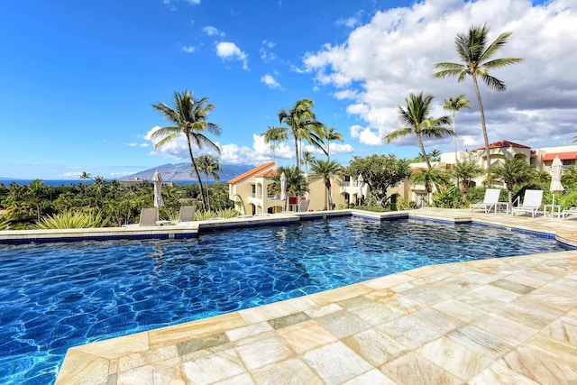 view of pool with a mountain view and a patio