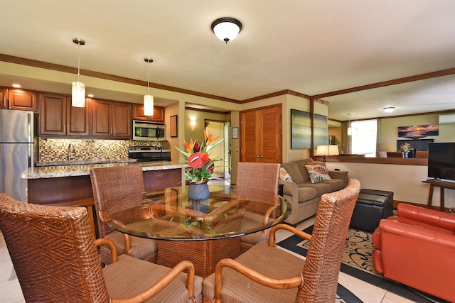 tiled dining area featuring crown molding