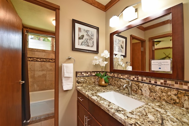 bathroom with shower / bathtub combination, ornamental molding, tile floors, and vanity