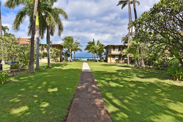 exterior space with a water view and a yard