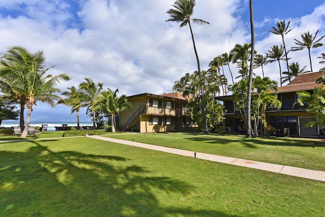 view of home's community featuring a water view and a yard