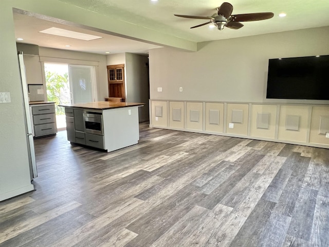 kitchen featuring ceiling fan, wooden counters, wood finished floors, and recessed lighting