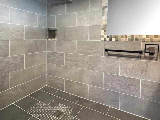 full bathroom with a tile shower