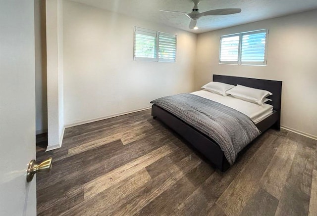 bedroom featuring multiple windows, wood finished floors, and ceiling fan